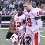 Seniors Randy Bryan and Ike Boettger leave the field with trophy in-hand after losing to Cedar Rapids Xavier.