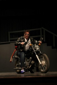 CFHS alum Josh Carlo sings while rolling a motorcycle on the CFHS auditorium stage during the 2013 spring musical, All Shook Up.